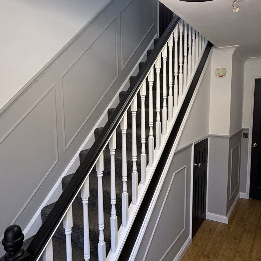 White and black staircase with grey panelling